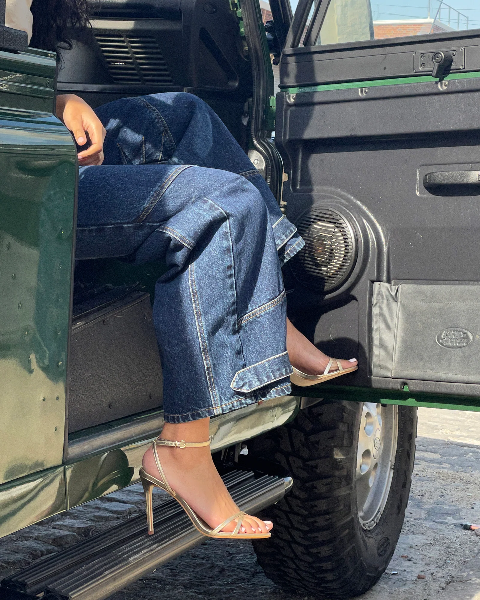Shoeliva paired with raw wide-leg denim and Land Rover Defender